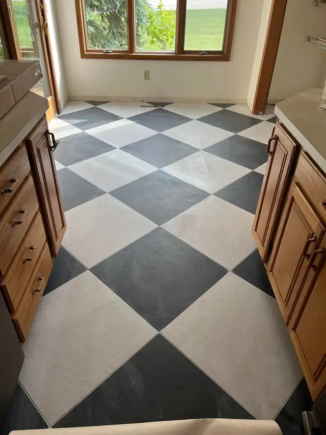 24 by 24 black and white porcelain floor tile set on the diagonal in a kitchen